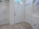 Bright and airy entryway with tile flooring and coat closet at 30111 Pga Dr, Mount Plymouth, FL 32776