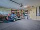 Organized garage with golf cart, workbench and ample storage at 30111 Pga Dr, Mount Plymouth, FL 32776