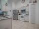 Kitchen with white cabinets, granite countertops, and stainless steel appliances at 30111 Pga Dr, Mount Plymouth, FL 32776