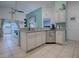 Kitchen with granite countertops, white cabinets, and island at 30111 Pga Dr, Mount Plymouth, FL 32776