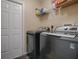 Convenient laundry room with washer, dryer, and overhead shelving at 30111 Pga Dr, Mount Plymouth, FL 32776