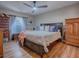 Spacious main bedroom with king-size bed, ample storage, and hardwood floors at 30111 Pga Dr, Mount Plymouth, FL 32776