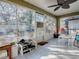 Bright screened porch with view of backyard and shoe storage at 30111 Pga Dr, Mount Plymouth, FL 32776