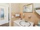 A second bathroom with peach tile and vanity at 32125 Mark Ave, Tavares, FL 32778