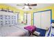 Bright bedroom with twin beds, ceiling fan, and a blue and yellow color scheme at 32125 Mark Ave, Tavares, FL 32778