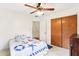 Simple bedroom with a nautical-themed bedspread and double door closet at 32125 Mark Ave, Tavares, FL 32778