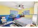 Cozy bedroom with a double bed, ceiling fan, and a blue and yellow color scheme at 32125 Mark Ave, Tavares, FL 32778