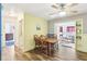 Bright dining area with wood table and chairs, view to cozy sunroom at 32125 Mark Ave, Tavares, FL 32778