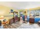 Bright living room with hardwood floors, antique furniture, and a view into the dining area at 32125 Mark Ave, Tavares, FL 32778