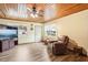 Living room with wood ceiling, fireplace, and leather recliner at 32125 Mark Ave, Tavares, FL 32778