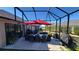 Spacious screened patio with table, chairs, and grill at 3257 Triton Ct, The Villages, FL 32163