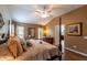 Main bedroom features a king-size bed and wood floors at 3257 Triton Ct, The Villages, FL 32163