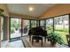 Sunroom with a grand piano and access to backyard patio at 3257 Triton Ct, The Villages, FL 32163