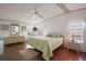 Bright bedroom with a king-size bed and wood floors at 3310 Manatee Rd, Tavares, FL 32778