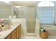 Bathroom boasts a double vanity, shower, and bathtub at 335 Grand Reserve Dr, Davenport, FL 33837