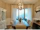 Elegant dining room featuring a large table, chandelier, and view to backyard at 335 Grand Reserve Dr, Davenport, FL 33837