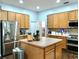 Modern kitchen with stainless steel appliances and an island at 335 Grand Reserve Dr, Davenport, FL 33837