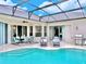 Inviting pool and patio with outdoor dining set and grill at 335 Grand Reserve Dr, Davenport, FL 33837