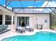 Relaxing pool area with covered patio and lounge chairs at 335 Grand Reserve Dr, Davenport, FL 33837