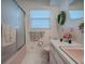 Pink bathroom with shower/tub combo, and hex tile floor at 33648 Picciola Dr, Fruitland Park, FL 34731