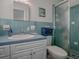 Light blue bathroom with shower and white vanity at 33648 Picciola Dr, Fruitland Park, FL 34731