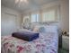 Bedroom with floral bedding, white dresser and nightstands at 33648 Picciola Dr, Fruitland Park, FL 34731