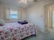 Bedroom with floral bedding, ceiling fan, and view of a window at 33648 Picciola Dr, Fruitland Park, FL 34731