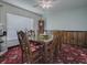 Dining room features a wood table, floral carpet, and ceiling fan at 33648 Picciola Dr, Fruitland Park, FL 34731