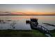 Lakefront property with a wooden dock and sunset view at 33648 Picciola Dr, Fruitland Park, FL 34731