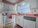 White kitchen with pink countertops and matching appliances at 33648 Picciola Dr, Fruitland Park, FL 34731