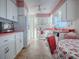 White kitchen with pink accents and a breakfast nook at 33648 Picciola Dr, Fruitland Park, FL 34731