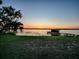 Stunning sunset over the lake, showcasing peaceful waterfront living at 33648 Picciola Dr, Fruitland Park, FL 34731