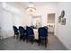 Elegant dining room with a large chandelier and blue velvet chairs at 3493 Edwards Road, Lady Lake, FL 32159