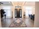 Bright and spacious entryway with a grand piano, chandelier, and stylish rug at 3493 Edwards Road, Lady Lake, FL 32159