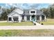 Two-story modern farmhouse with black windows, light-colored siding, and landscaped yard at 3493 Edwards Road, Lady Lake, FL 32159