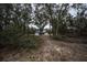 White two-story house with black windows, gray roof, and a long driveway at 3493 Edwards Road, Lady Lake, FL 32159