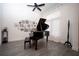 Dedicated music room featuring a grand piano and gallery wall at 3493 Edwards Road, Lady Lake, FL 32159