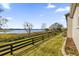 Landscaped backyard with lake view and wooden fence at 3545 Lia Ln, The Villages, FL 32163