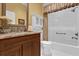 Clean bathroom with a bathtub and granite countertop at 3545 Lia Ln, The Villages, FL 32163