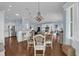 Bright dining area with hardwood floors and view into the living room and kitchen at 3545 Lia Ln, The Villages, FL 32163