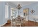 Elegant dining room with hardwood floors, chandelier, and built-in hutch at 3545 Lia Ln, The Villages, FL 32163