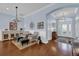 Bright and airy entryway with hardwood floors, decorative chandelier, and seating area at 3545 Lia Ln, The Villages, FL 32163