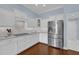 Modern kitchen with white cabinets, granite countertops, and stainless steel appliances at 3545 Lia Ln, The Villages, FL 32163