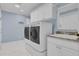 The laundry room features a front load washer and dryer, sink, and built in cabinets at 3545 Lia Ln, The Villages, FL 32163