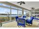 Bright sunroom with water views and comfortable seating at 3545 Lia Ln, The Villages, FL 32163