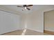 Bedroom with a closet, neutral walls, ceiling fan and tile floors at 35808 Rose Moss Ave, Leesburg, FL 34788