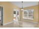 Bright dining area featuring sliding glass doors to the backyard, with tile flooring and classic light fixture at 35808 Rose Moss Ave, Leesburg, FL 34788