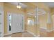 Inviting foyer featuring tile flooring, decorative columns, and a stylish entry door at 35808 Rose Moss Ave, Leesburg, FL 34788