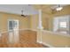 Bright living room featuring wood floors, neutral walls, and access to the outdoor patio at 35808 Rose Moss Ave, Leesburg, FL 34788