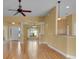 Spacious living room featuring wood floors, decorative columns, and natural light at 35808 Rose Moss Ave, Leesburg, FL 34788